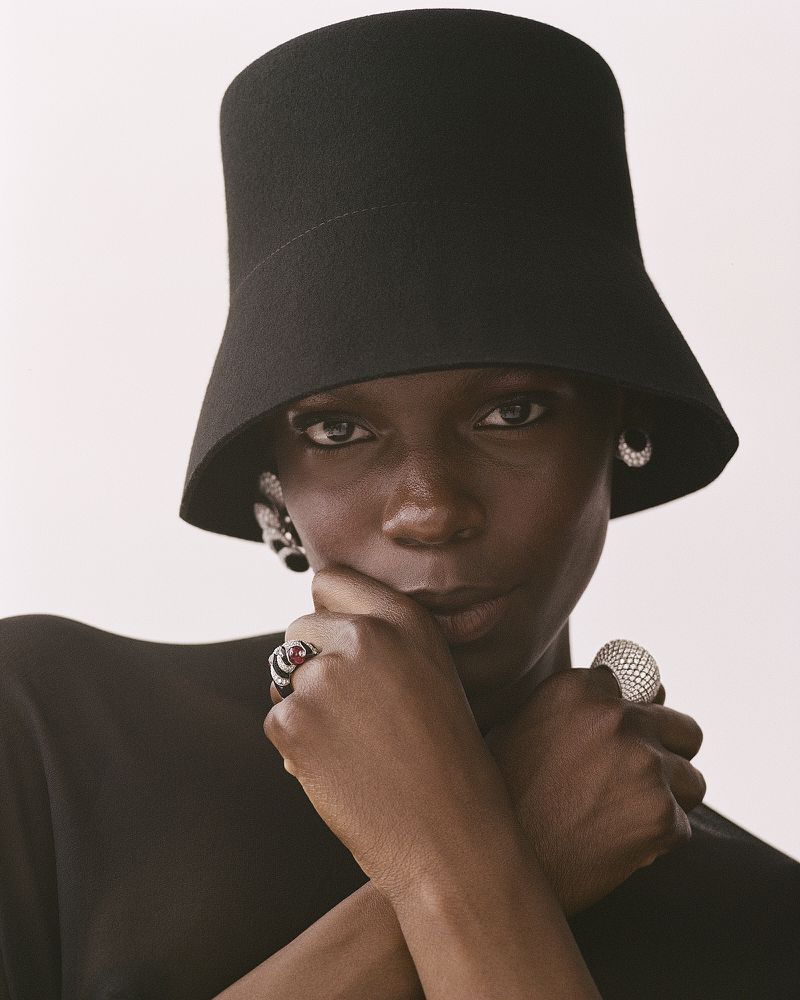 Model Agel Akol wearing a black hat and rings for Heroine Magazine photographed by Anna Daki