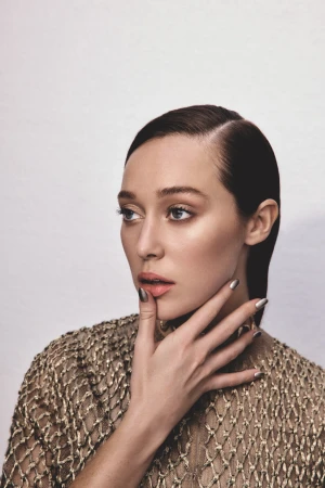 Portrait of Alycia Debnam Carey in a gold mesh top with metallic nails against a neutral white background