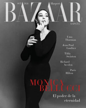Monica Bellucci on the cover of Harper's Bazaar Espana wearing a long black dress against a grey studio backdrop