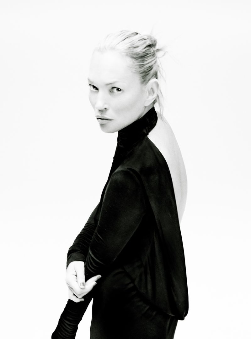Portrait of model Kate Moss wearing a black long-sleeve top against a white seamless background for The Perfect Magazine.