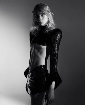 Model in black textured top and skirt against a grey studio backdrop, photographed by Marlen Keller for theBallroom.