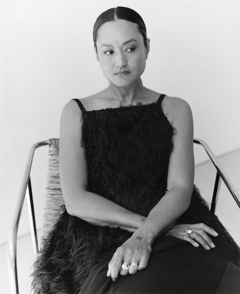 Black and white portrait of Autumn Durald Arkapaw seated in a chair wearing a textured dark dress for The Gentlewoman.