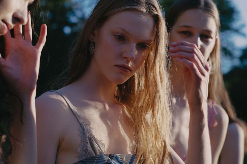 Three female models posing outdoors in natural light for the Dreaming Beyond the Fields editorial project.