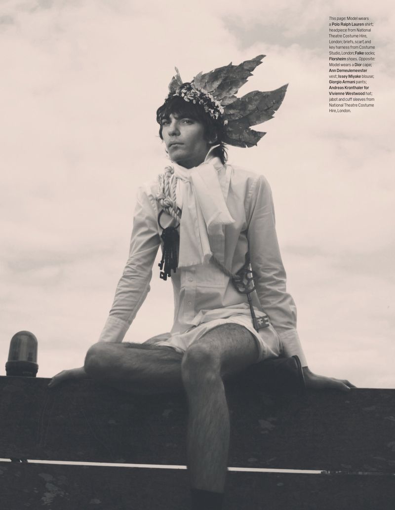 Model wearing a white shirt and leaf crown seated against an overcast sky for W Magazine editorial