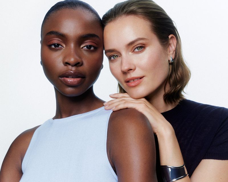 Two models posing together against a white background for the Saie Supersuede Eyeshadow Campaign