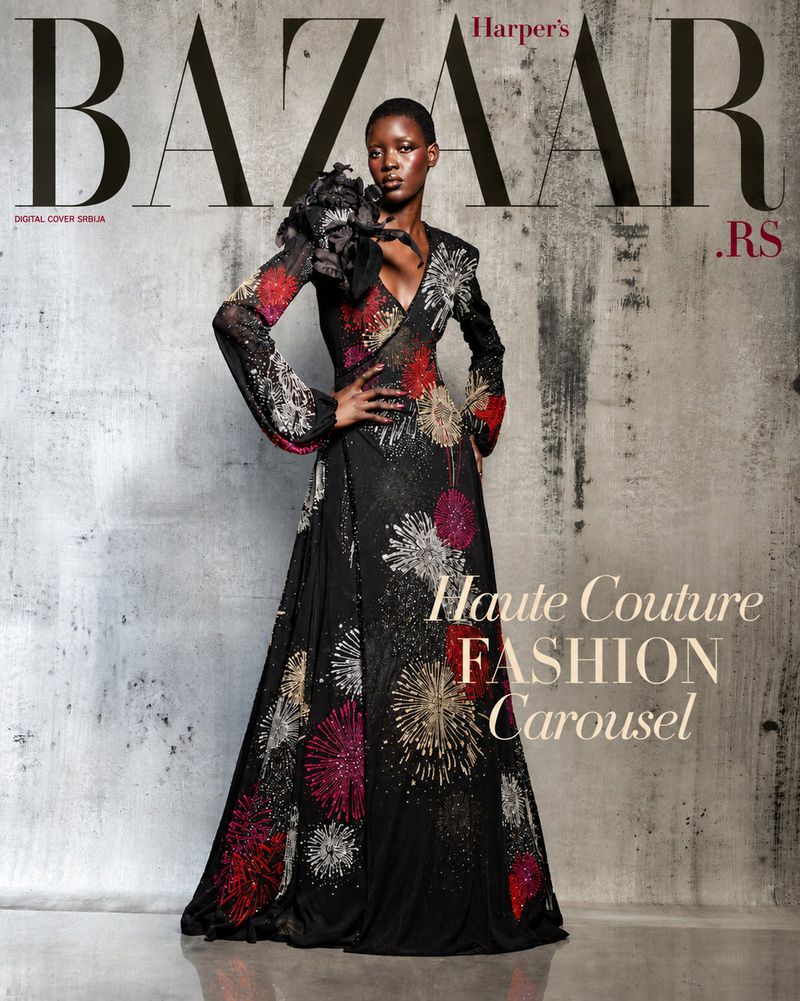 Model Ayak Veronica Bior wearing an embellished black gown with a decorative shoulder piece against a textured concrete background