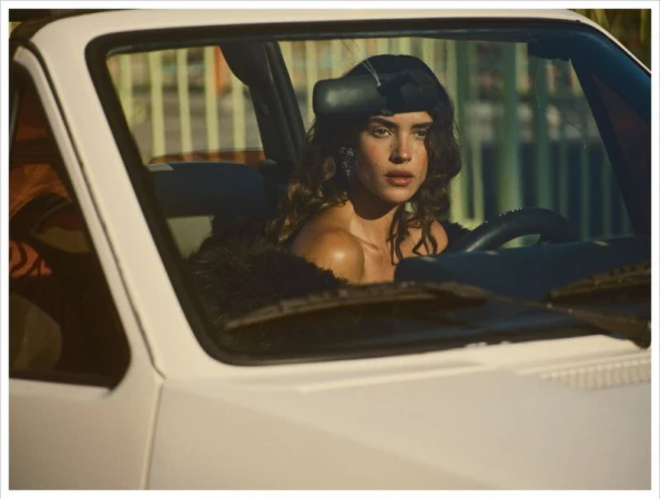 Adria Arjona seated inside a white convertible car for Vogue Mexico El Sueno De Adria editorial