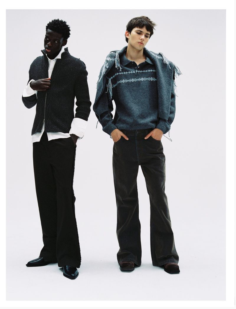Two male models posing against a white seamless background in contemporary designer fashion apparel by Oscar Ouyang.