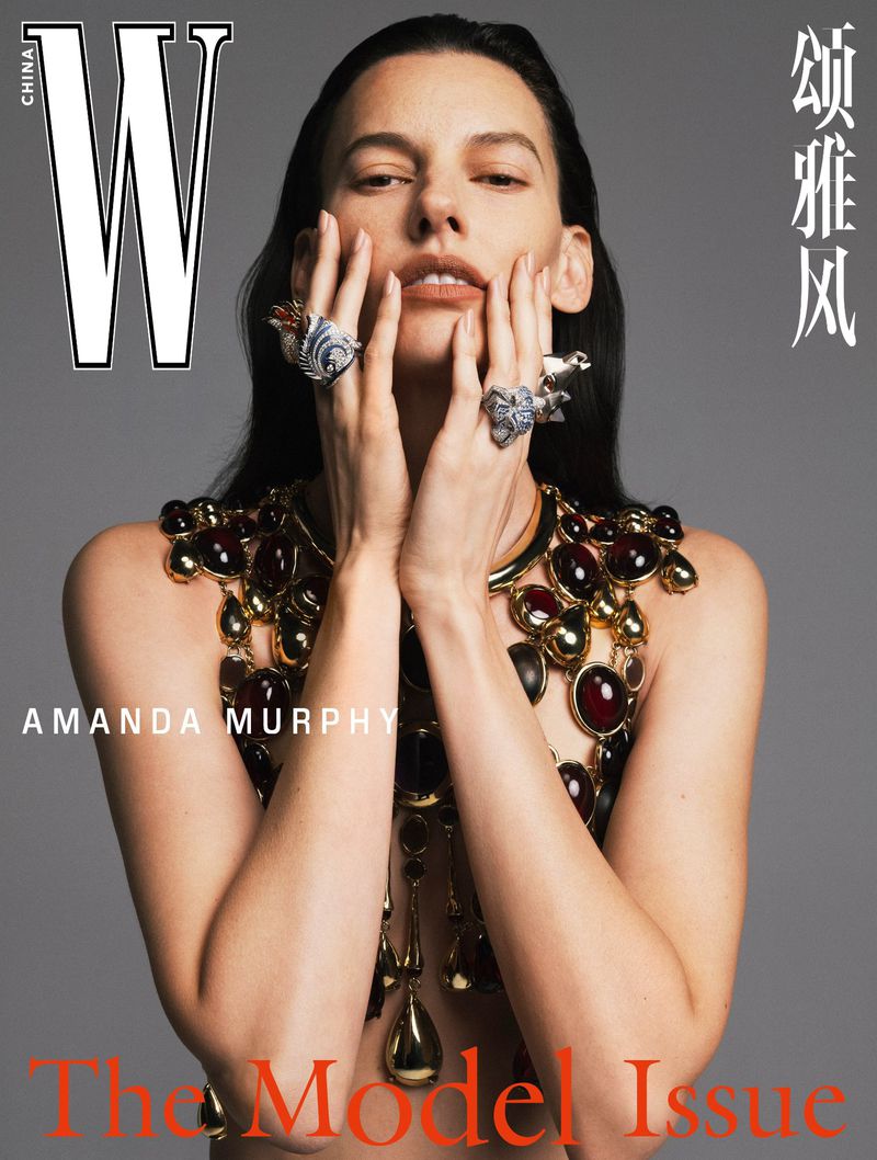 Model Amanda Murphy wearing ornate jeweled collar and statement rings against a grey seamless backdrop for W Magazine China cover