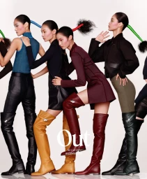 Group of female models posing in layered outfits and tall boots against a white studio background for T Magazine China.