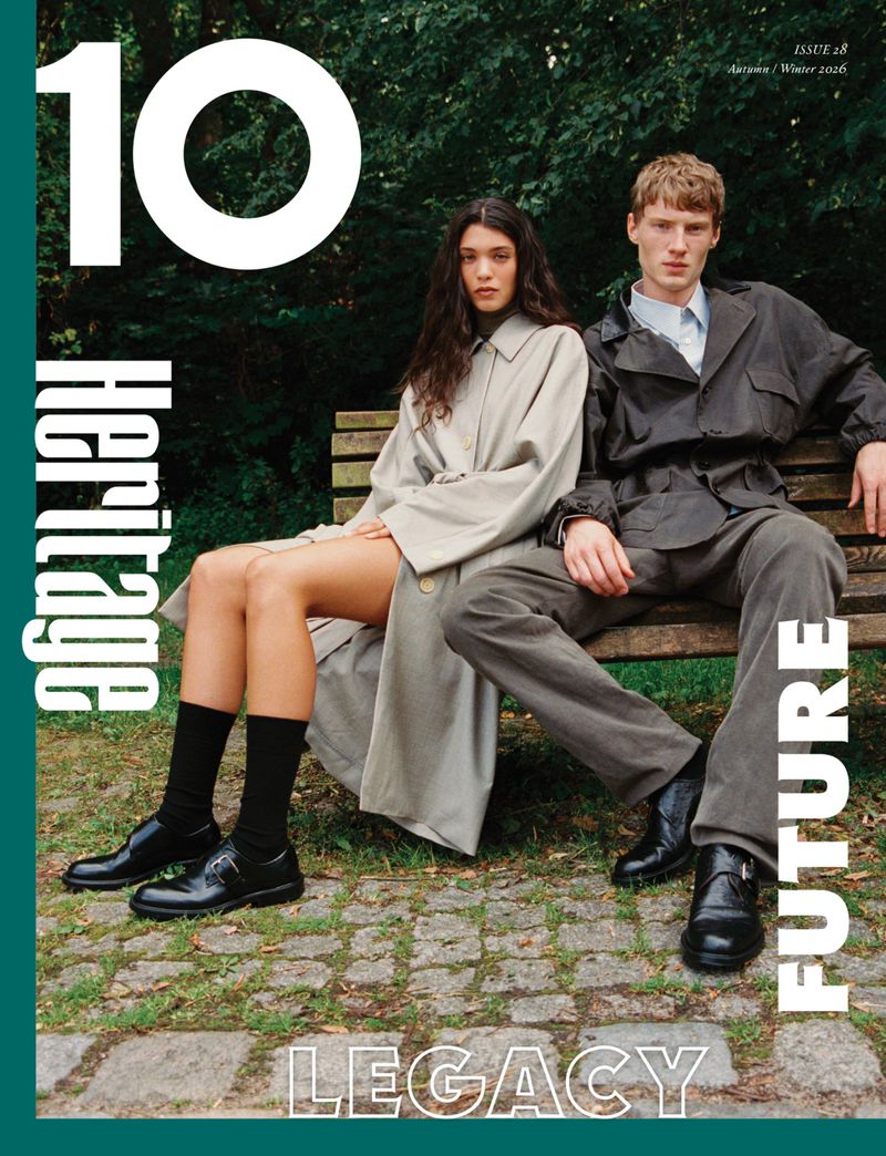Two models seated on a park bench outdoors against a leafy green background, featured in 10 Magazine Australia issue 28.