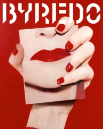 Close-up of hands holding a photograph showing red lips against a vibrant red backdrop with white Byredo text