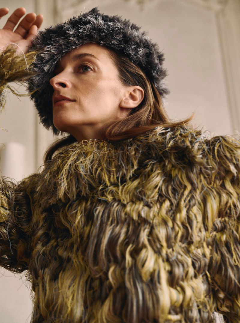 Model Roos van Bosstraeten wearing a textured green coat and fuzzy hat for Mixte magazine