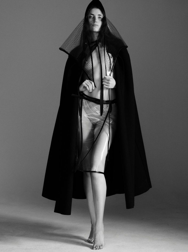 Grace Hartzel in black hooded cape and sheer plastic overlay for Pop Magazine fashion editorial