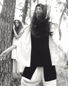 Two female models posing among pine trees outdoors in a black and white fashion editorial by Oliver Hadlee Pearch for Pop Magazine.