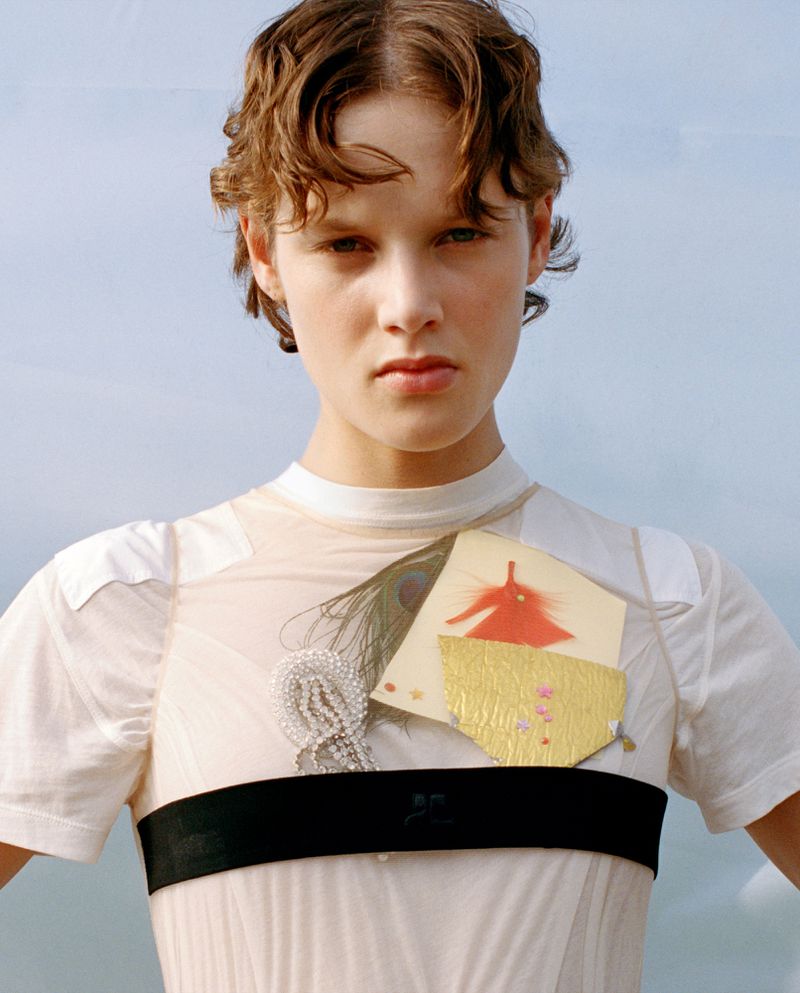 Close-up portrait of model Noor Khan wearing a white sheer top with decorative embellishments for The Gentlewoman by Esther Theaker.