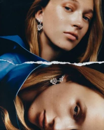 Close-up portrait of a woman wearing a blue jacket and diamond earrings, presented as a torn collage layout.
