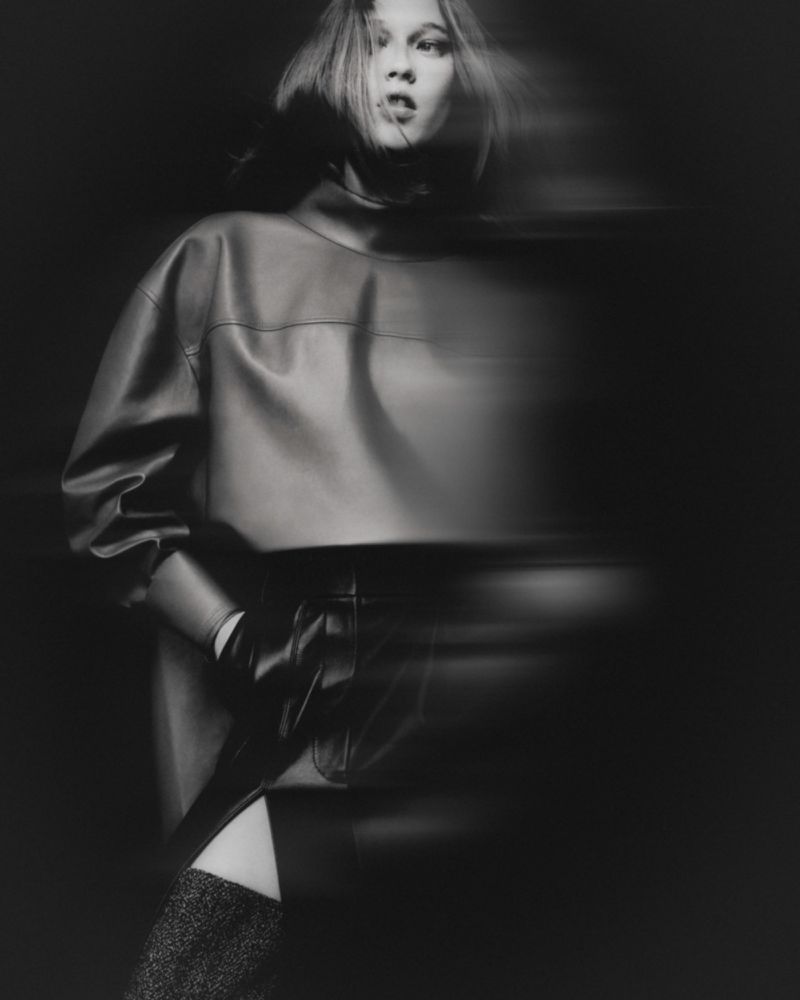 Model in dark leather top and high boots with motion blur against dark background for Mixte In the Shadows