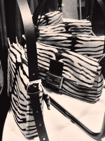Zebra-print calf hair shoulder bag with a black leather strap displayed in a mirror reflection for Vogue Czechoslovakia