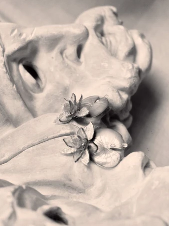 Monochrome close-up of sculpted floral jewellery resting on a classical stone bust for Vogue Czechoslovakia