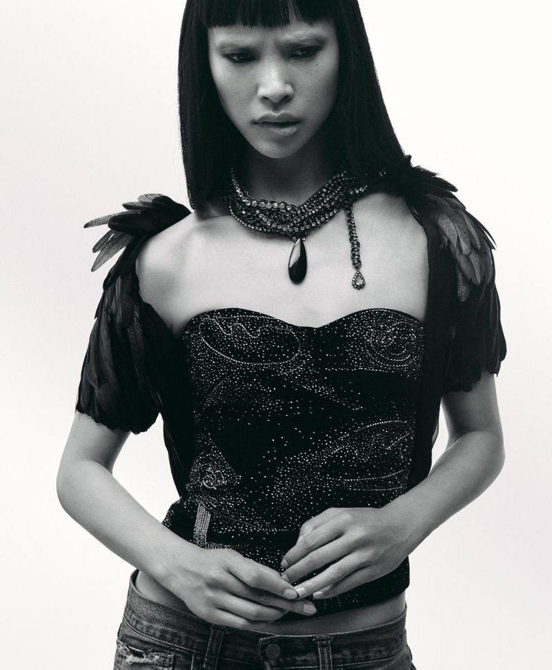 Model Diane Chiu in a black embellished strapless top and feathered sleeves, photographed by Arseny Jabiev for Rouge Fashionbook.