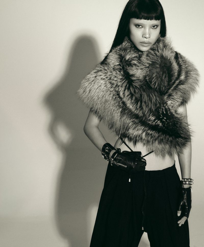 Model Diane Chiu in a fluffy faux fur wrap and dark gloves against a plain studio background for Rouge Fashionbook.