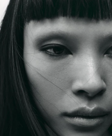 Close-up monochrome portrait of model Diane Chiu with straight bangs and dark hair for Rouge Fashionbook editorial by Arseny Jabiev.