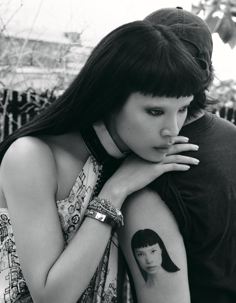 Model Diane Chiu leaning on a person's shoulder in a black and white editorial photograph for Rouge Fashionbook