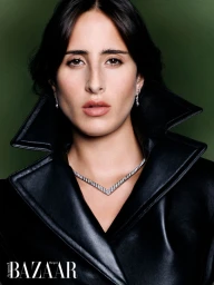 Model Taleedah Tamer wearing a black leather coat and diamond necklace in a portrait for Harper's Bazaar Arabia.