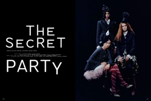 Three models in dark tailored jackets and hats posing against a black studio background for Mixte magazine editorial.