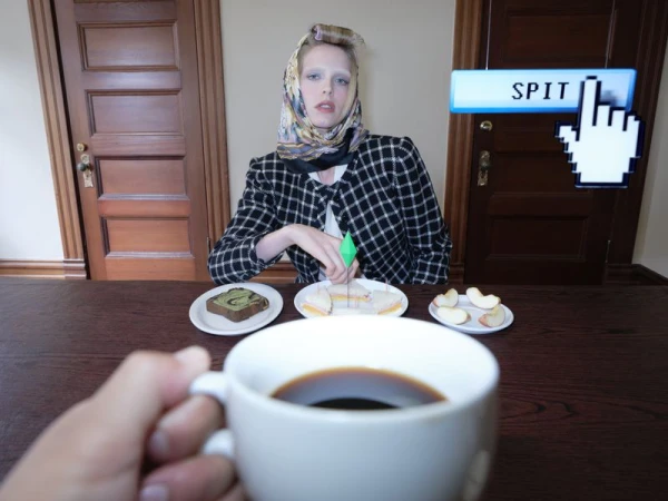 Model wearing a plaid jacket and headscarf sits at a wooden table with plates of food, featuring a floating computer cursor graphic.