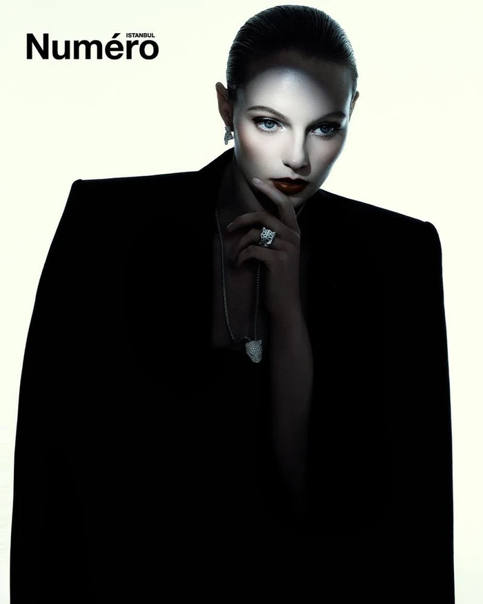 Model Fran Summers wearing a black blazer and necklace against a bright white background for Numero Istanbul