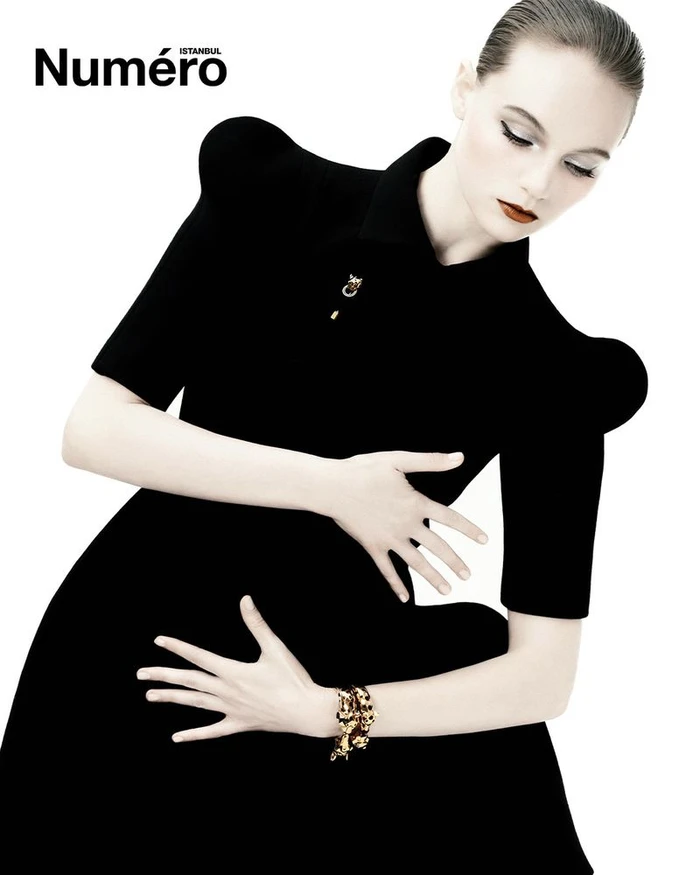 Model Fran Summers wearing a black dress against a white background for Numéro Istanbul