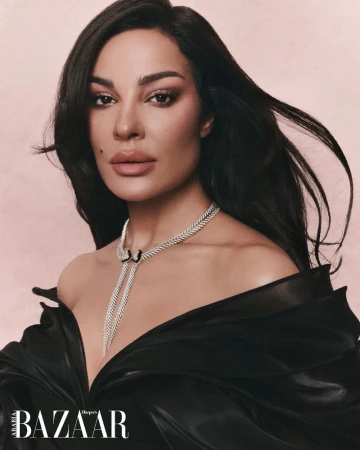 Portrait of Nadine Njeim wearing a diamond necklace and black top for Harper's Bazaar Arabia editorial