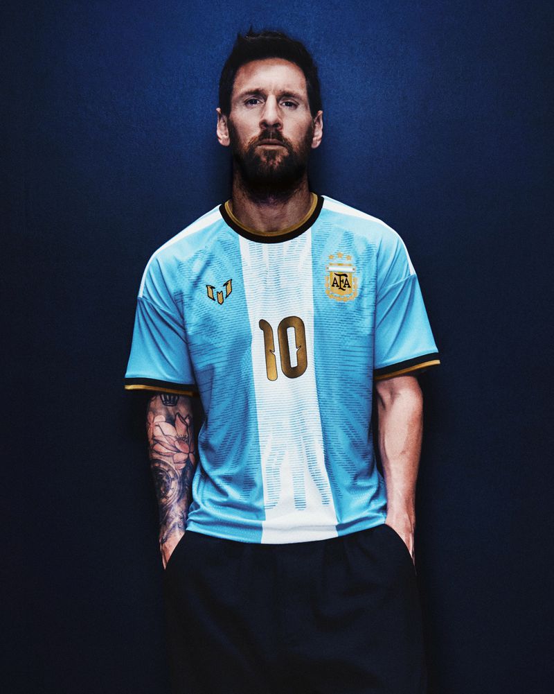 Lionel Messi wearing a light blue and white Argentina jersey with the number 10 against a dark textured blue background