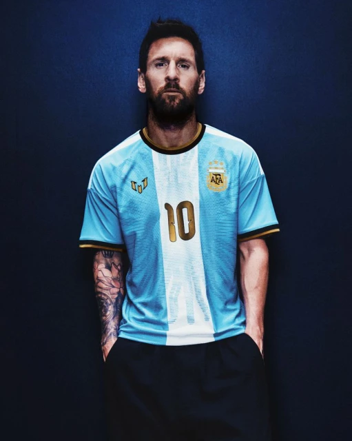 Lionel Messi wearing a light blue and white Argentina jersey with the number 10 against a dark textured blue background