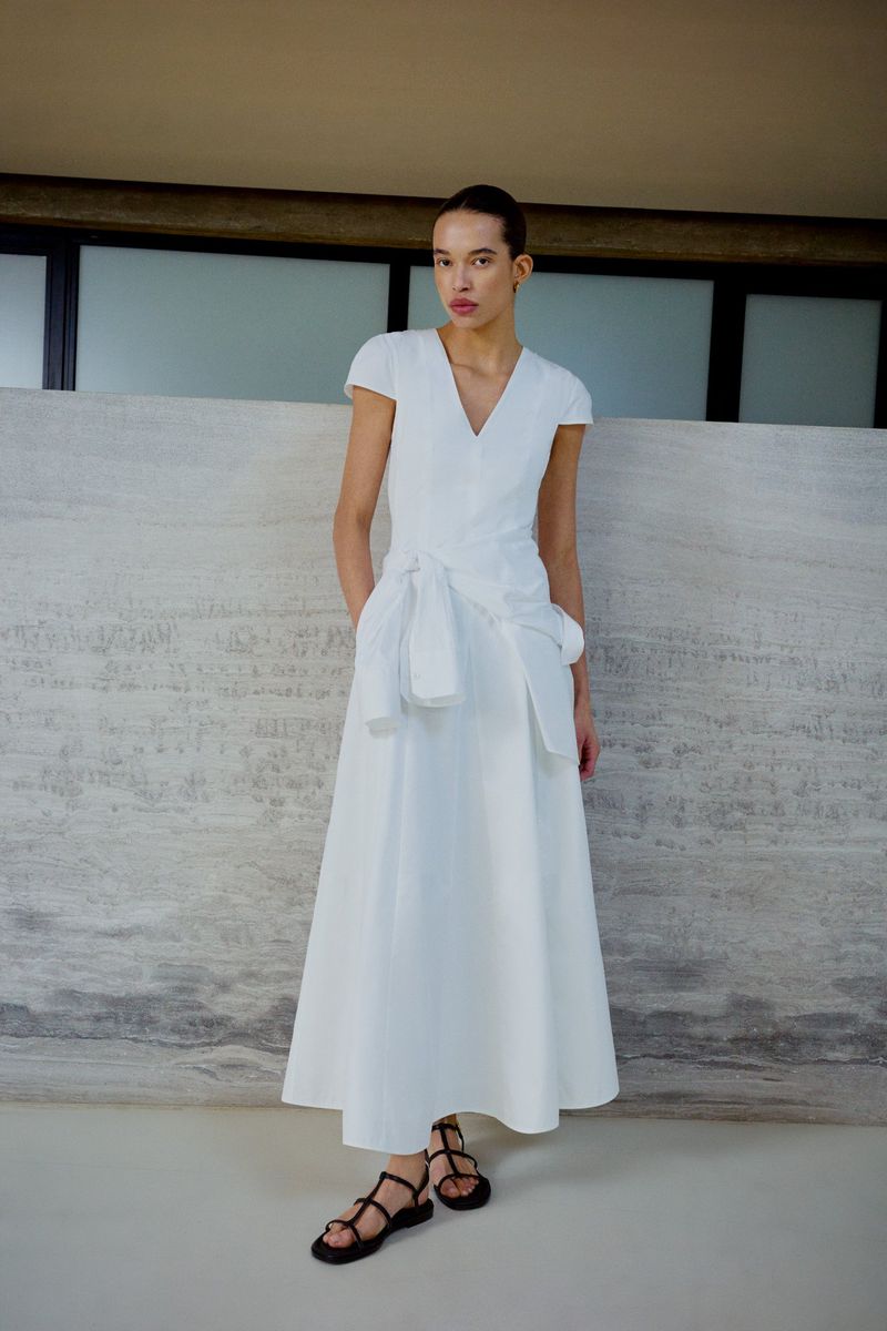 Model Lara Menezes wearing a white cap-sleeve maxi dress and black strappy sandals for the ME+EM June Lookbook