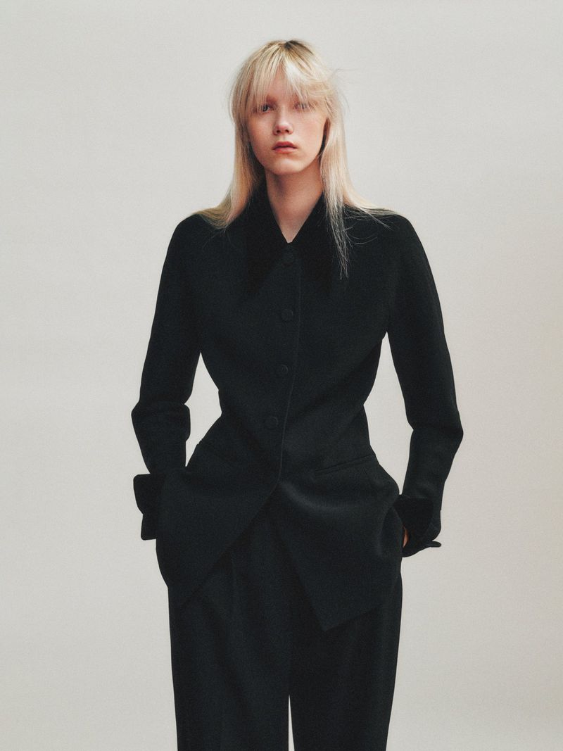 Model wearing a structured black blazer against a neutral backdrop for The Gentlewoman editorial project