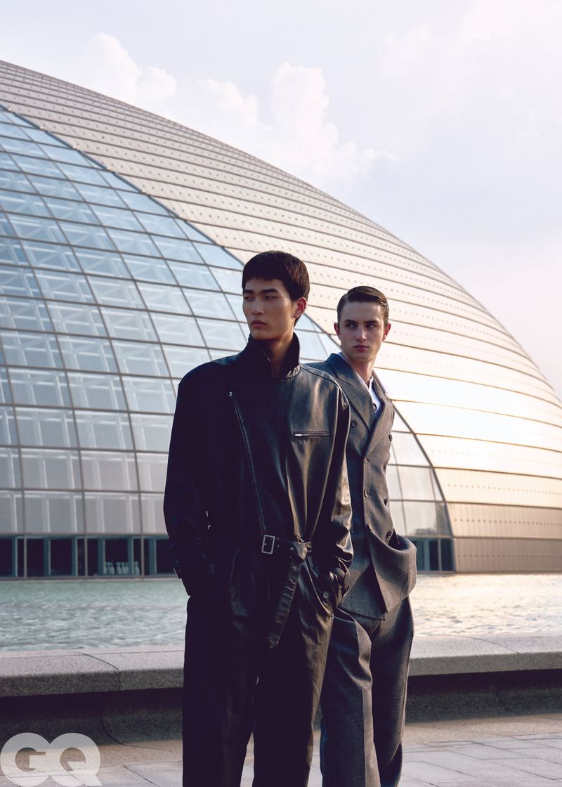 Two male models posing in front of a modern domed glass building for GQ China editorial project