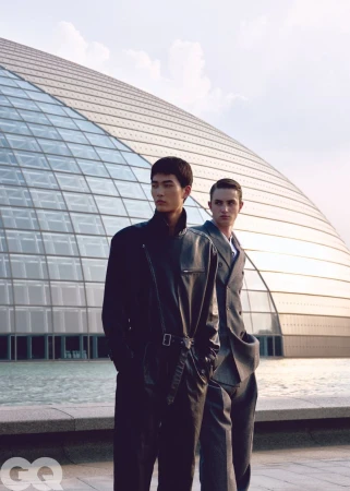 Two male models posing in front of a modern domed glass building for GQ China editorial project