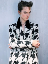 Model Caro Casay wearing a black and white patterned coat against a grey wall for Harper's Bazaar Turkey