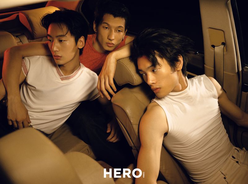 Three young men posed inside a car interior with warm directional lighting for HERO Magazine editorial