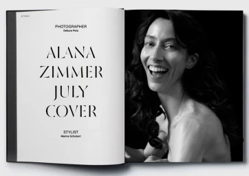Black and white editorial magazine spread featuring model Alana Zimmer smiling against a dark background