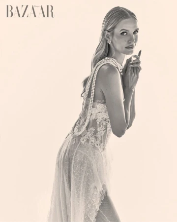 Model Leonie Hanne wearing a white lace dress with pearl necklace for Harper's Bazaar Vietnam, photographed by Giuseppe Vitariello