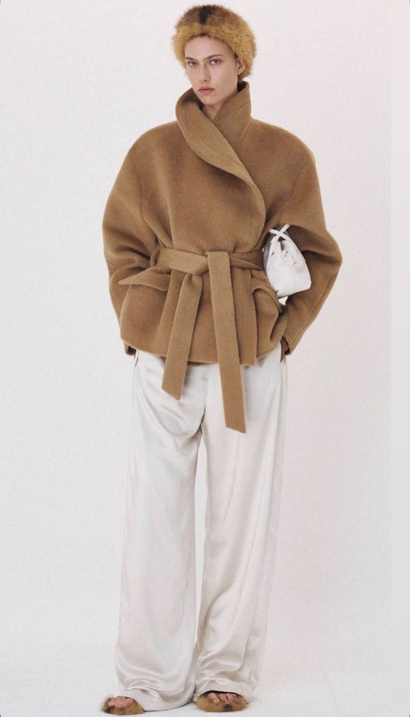 Model wearing a brown wool jacket and white trousers against a plain white background for Recto Fall/Winter 2026.