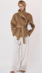 Model wearing a brown wool jacket and white trousers against a plain white background for Recto Fall/Winter 2026.