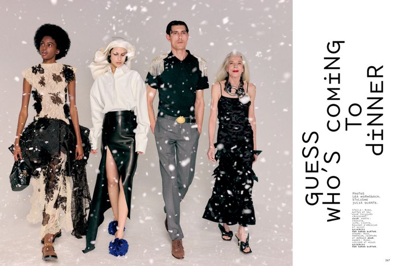 Four diverse models posing in high fashion winter apparel against a pale grey backdrop with falling snow effects