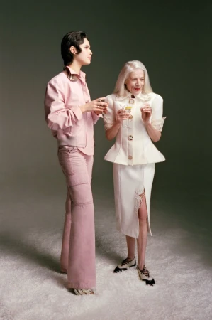 Two models holding cocktails against a neutral studio backdrop for Mixte magazine editorial photography