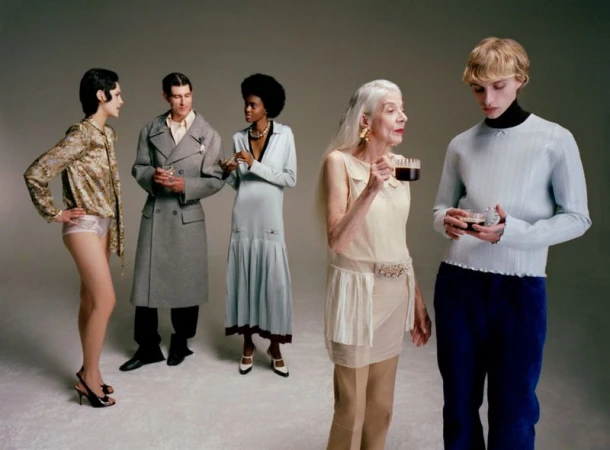 Group of five diverse models standing on a seamless grey backdrop holding cups and glasses for Mixte magazine editorial.