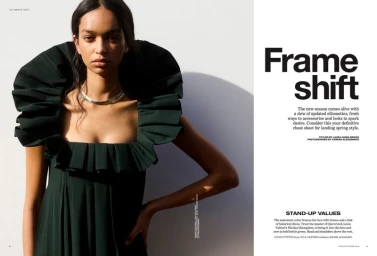 Model wearing a dark green dress with an exaggerated ruffled collar against a bright white background for Vogue Australia